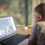boy watching video using laptop