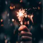 photo of a person holding a sparkler