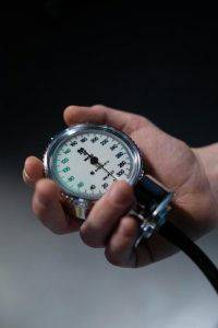 close-up-photo-of-a-person-holding-a-sphygmomanometer-gauge